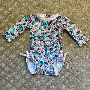 Ruffle Butts long sleeve one piece rash guard swim suit. 3-6 months. Like new